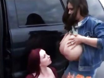 A woman sucks a pair of lactating breasts